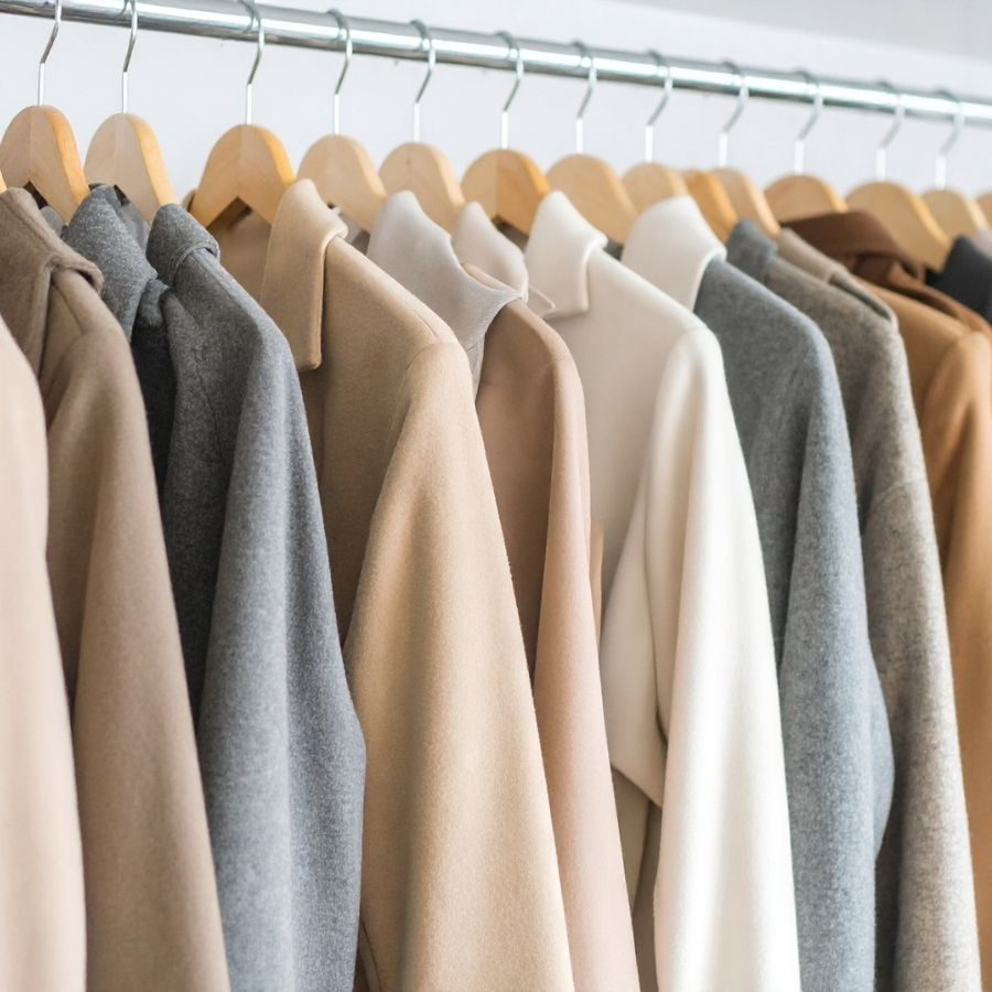 picture of neutral clothing hanging on a clothes rack